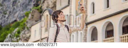 Banner, Long Format Man Tourist In Monastery Of Ostrog, Serbian Orthodox Church Situated Against A V