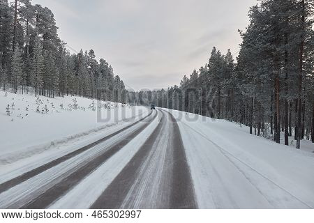 Driving On Snowy Winter Roads Of Finnish Lapland, Arctic Landsape, Icy Asphalt
