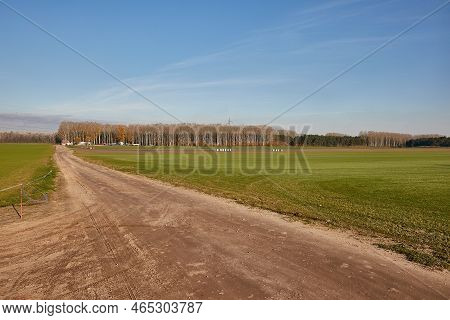 Agricultural Field With Dirt Road To The Distance On A Plain, Steads In Hungary