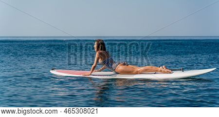 Sporty Girl On A Glanders Surfboard In The Sea On A Sunny Summer Day. Summer Activities By The Sea