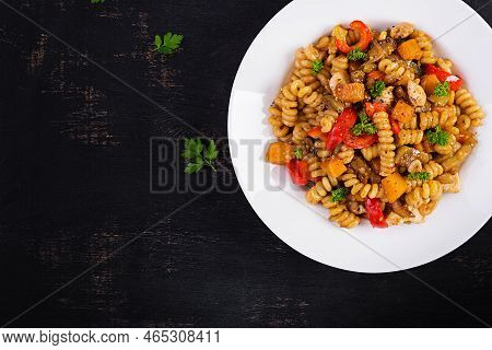 Vegetable Pasta Fusilli Corti Bucati With Eggplant, Sweet Pepper And Chicken In White Plate On Dark 