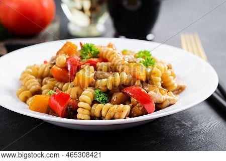 Vegetable Pasta Fusilli Corti Bucati With Eggplant, Sweet Pepper And Chicken In White Plate On Dark 