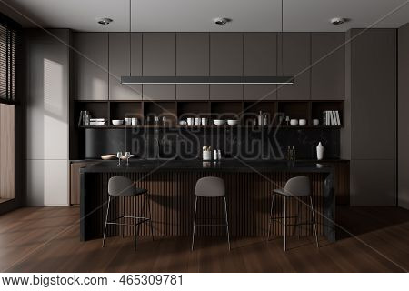 Front View On Dark Kitchen Room Interior With Island With Barstools, Brown Wall, Oak Wooden Hardwood