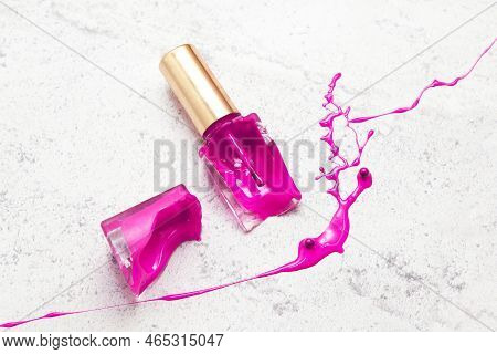 Violet Broken Nail Polish Bottle On Marble, Dye Color Glass Jar Splash And Drops Or Suffusion