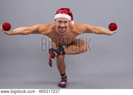 Crazy Santa. Naked Gay Santa In Santa Head Funny Yaga Posing On Gray Studio Background.