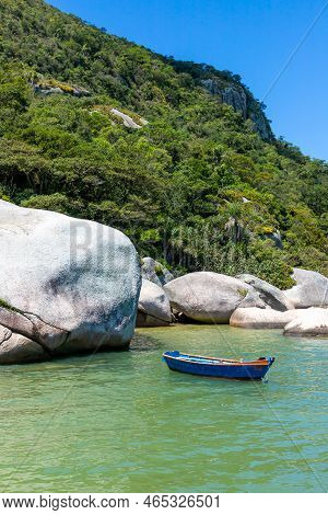 Fisherman Boat With Rocks And Forest