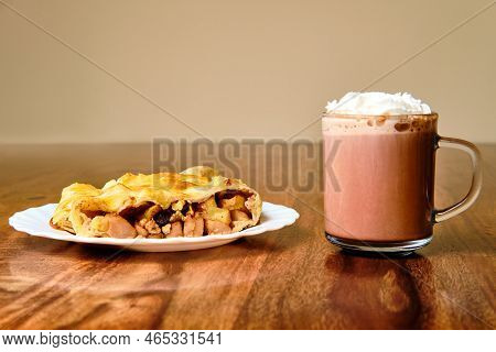 Tasty Apple Strudel On Plate With Cocoa Drink In Glass On Wooden Table