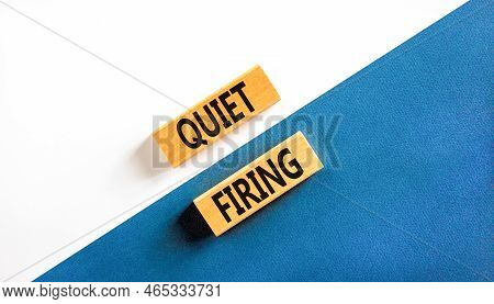 Quiet Firing Symbol. Concept Words Quiet Firing On Wooden Blocks. Beautiful White And Blue Backgroun