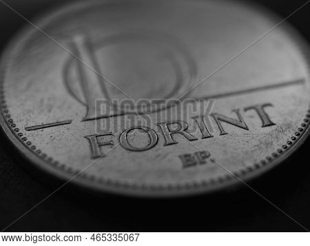 Hungarian Coin Of 10 Forints Lies On A Dark Surface Closeup. Money Of Hungary. News About Economy Or