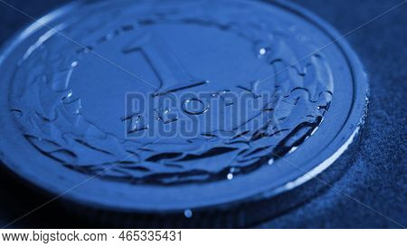 Translation: 1 Zloty. Polish One Zloty Coin Closeup. National Currency And Money Of Poland. Dark Blu