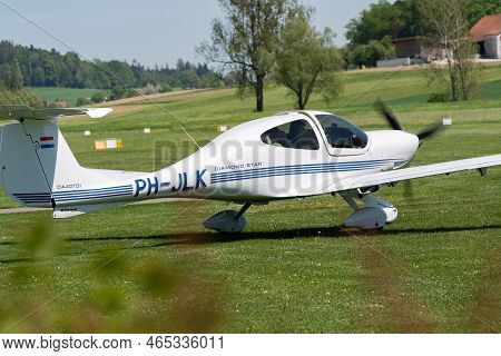 Lommis, Switzerland, May 11, 2022 Diamond Da40d Propeller Plane Is Taxiing On The Grass On A Small A