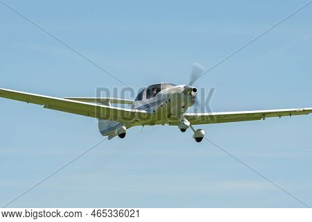Lommis, Switzerland, May 11, 2022 Diamond Da40d Propeller Plane In The Blue Sky