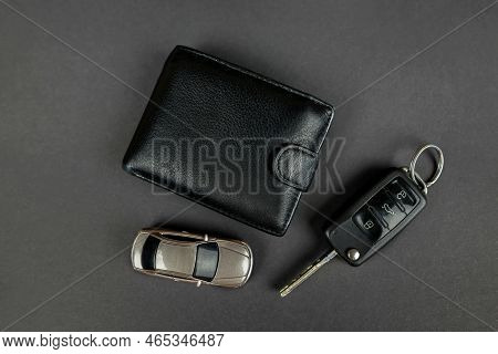 Gray Toy Car With Keys And A Wallet On A Gray Background, Top View