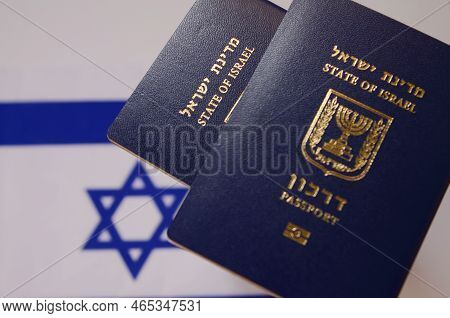 An International Biometric Passport Of A Citizen Of Israel Against The Background Of The Flag Of Isr