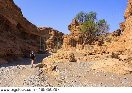 Sesriem Canyon, Namibia - 30 September 2018: A Woman Walking In The Sesriem Canyon. Natural Canyon C