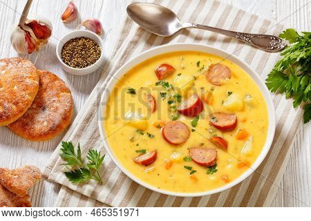 Kartoffelsuppe, German Potato Soup With Sausages In White Bowl On White Wooden Table