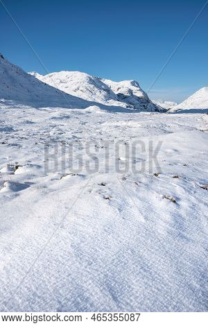Beautiful Winter Landscape Blue Sky Image Of View Along Glencoe Rannoch Moor Valley With Snow Covere