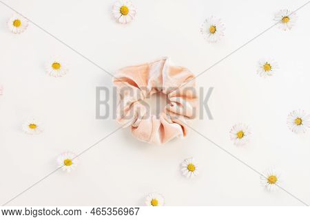 One Trendy Pink Velvet Scrunchie And Fresh Spring Daisy Flowers On Whitel Background. Flat Lay, Top 