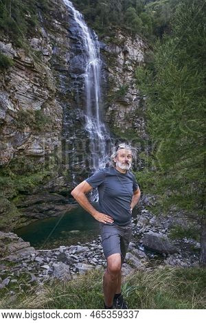Man Under The Froda Waterfall In Sonogno, Switzerland