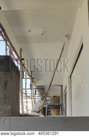 Man Painting On Ceiling Of Building With White Paint In Hyderabad, Telangana, India