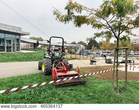 Strasbourg, France - Oct 20, 2022: Rear View Of Tractor Carrying Red Powerful Lipco Lawn Seeder Aera