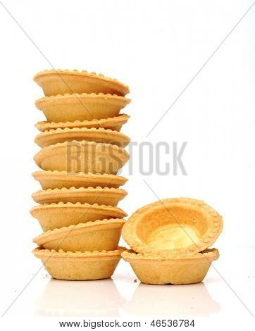 A stack of empty tartlets on white background