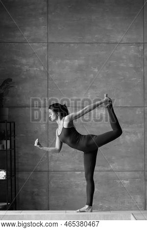 Black And White Photo. Dancer Working Out Indoors.side View Full Length Photo.flexibility, Grace, Gr