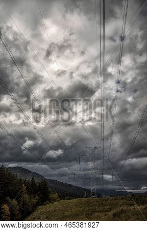 High Voltage Electric Pylon And Electrical Wire In Country. Electricity Pylon With Cloudy Sky. High 