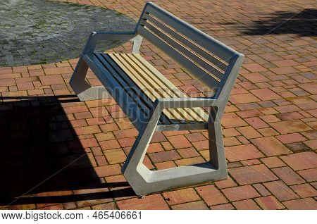 Light Concrete Park Bench, Elegant Cast Frame And Light Wooden Seat And Backrest Made Of Planks. Bro
