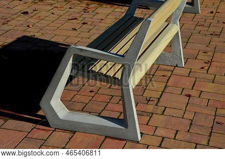 Light Concrete Park Bench, Elegant Cast Frame And Light Wooden Seat And Backrest Made Of Planks. Bro
