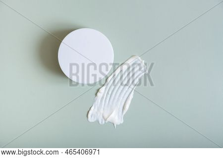 Cosmetic Smear And Creame Box On Colored Background Top View