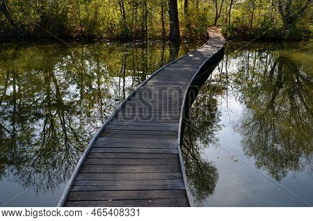Floating Walkway Made Of Wooden Planks. Narrow Curved Paths On Stilts Driven Into The Bottom, Above 