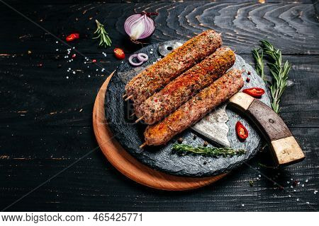 Raw Lula Kebab On Skewers With Spices Dark Background. Lula Kebab, Traditional Caucasian Dish. Top V