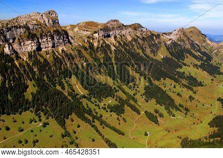 Landscape With The View Of The Mountain Range, A Hollow And Houses In It Against A Blue Sky With Clo