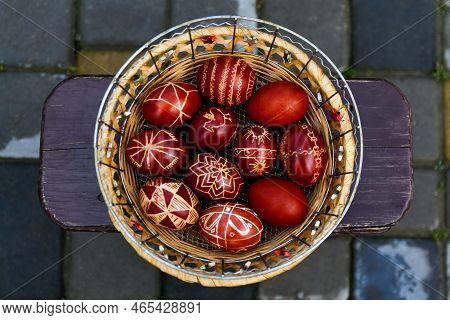 Defocus Closeup Of Basket Of Colored Red Eggs, Easter Holiday Concept. Modern Painted Easter Eggs. N