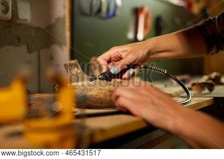 Female Using Power Wood Working Tools Graver, Carving While Crafting