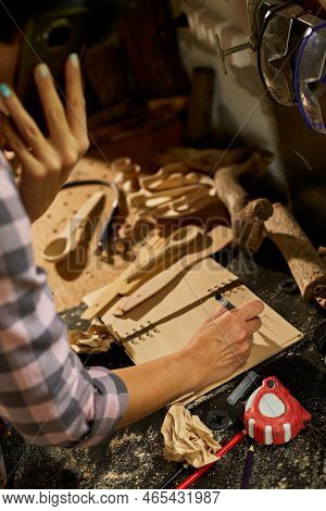 Close Up Of Carpenter Woman Hand Makes Notes Of Order Details With Her Customer