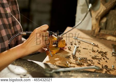 Woman Using Power Working Grinder Machine, Female Hand Grinds A Metal Nuts