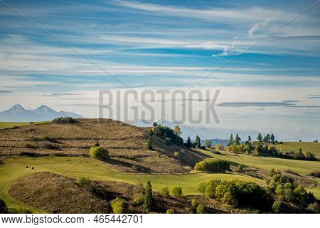Mountain Scenery With Green Pastures And Rocky Tatra Mountains In The Background During The Day.