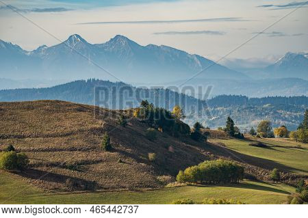 Mountain Scenery With Green Pastures And Rocky Tatra Mountains In The Background During The Day.