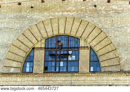 Old Window In The Form Of An Arch With Broken Glass