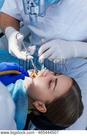 The Dentist Examines The Patient's Teeth Using Dental Equipment. Modern Medical Equipment. Anesthesi