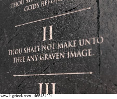 A View Of The Second Commandment Etched Into A Cracked Stone Tablet On An Isolated Background - 3d R