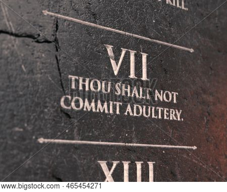 A View Of The Seventh Commandment Etched Into A Cracked Stone Tablet On An Isolated Background - 3d 