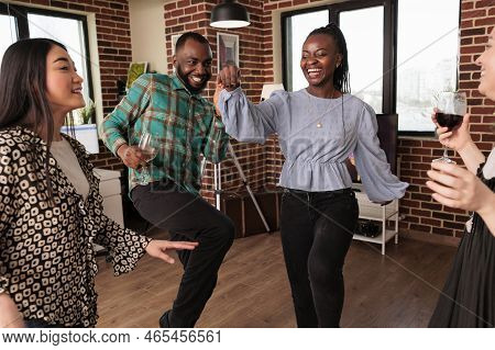 Young Adult African American Woman Dancing, Smiling Amidst A Different Ethnicities, Nationalities Pe