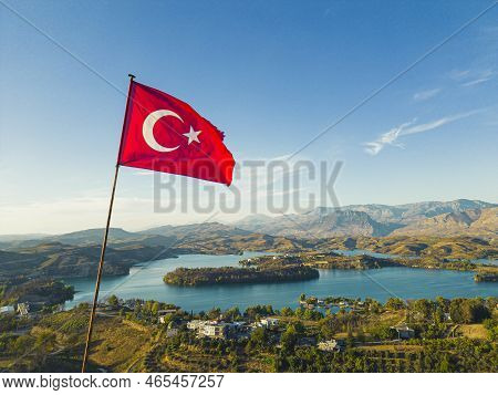 Turkish Flag Fluttering Above Picturesque Green Lake Manavgat. Lush Green Mountainous Landscape With