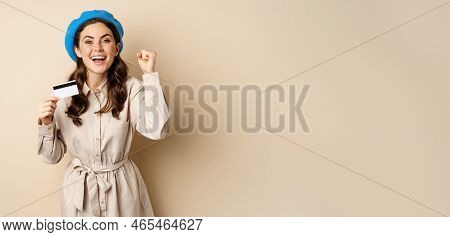 Enthusiastic Young Woman Yearning To Go Shopping, Dancing With Credit Card And Celebrating, Laughing