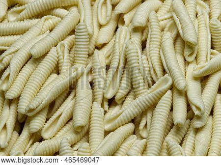 Uncooked Italian Maccheroni Al Pettine Pasta Background.