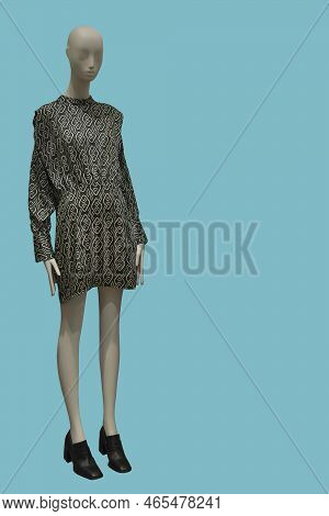 Full Length Image Of A Female Display Mannequin Wearing Fashionable Collarless Green Long Sleeved Dr