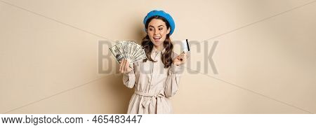 Microcredit And Money Concept. Young Stylish Woman Showing Credit Card And Dollars Cash, Smiling Hap
